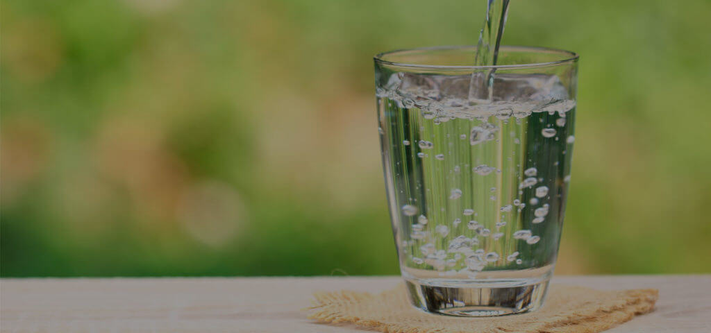 water-softener_Closeup-Glass-of-water-on-table-nature-background